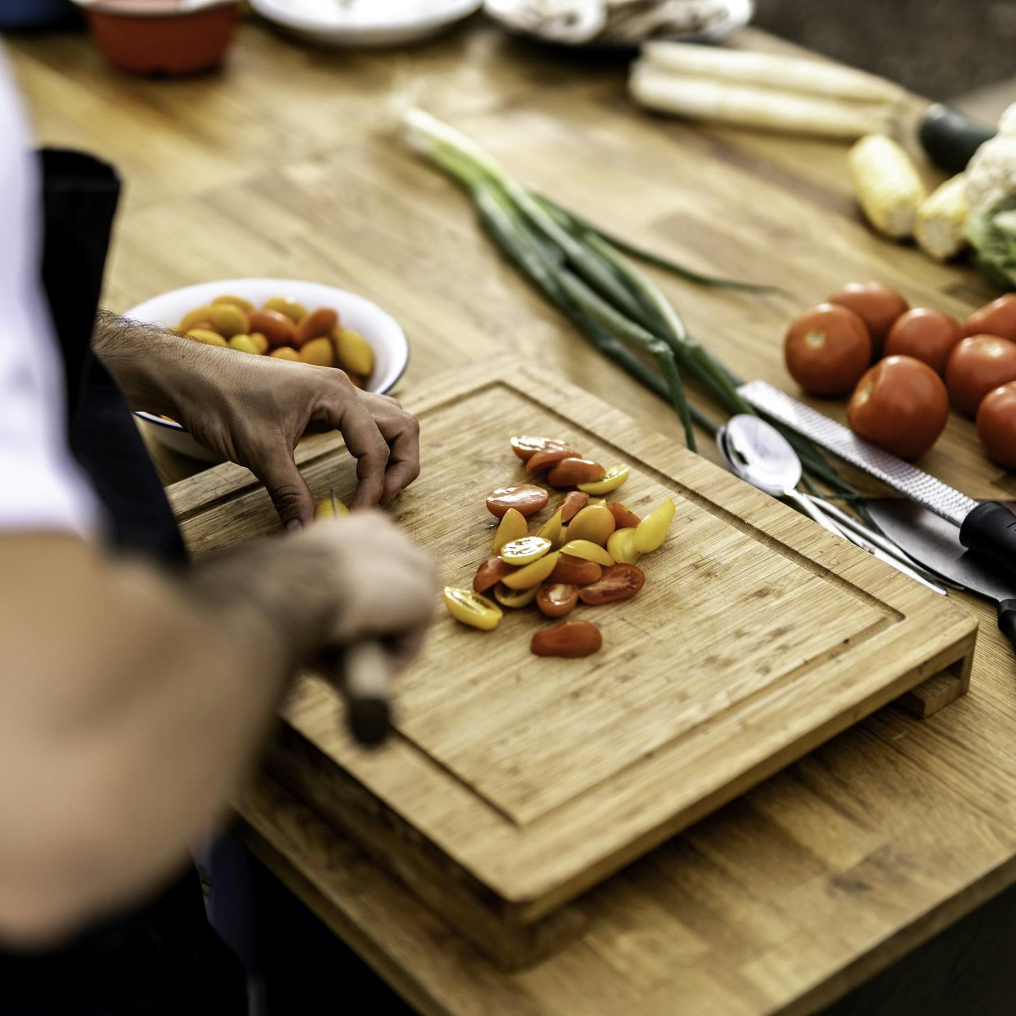 Community members collaborating in a modern kitchen space, sharing recipes and cooking techniques